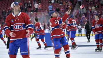 Apr 16, 2024; Montreal, Quebec, CAN; Montreal Canadiens forward Tanner Pearson (70) and teammates including forward Rafael Harvey-Pinard (49) throw souvenirs to fans after a game against the Detroit Red Wings at the Bell Centre. Mandatory Credit: Eric Bolte-USA TODAY Sports