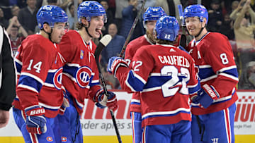 Apr 9, 2024; Montreal, Quebec, CAN; Montreal Canadiens forward Juraj Slafkovsky (20) celebrates with teammates including defenseman Mike Matheson (8) and Montreal Canadiens forward Nick Suzuki (14) and  forward Cole Caufield (22) after scoring a goal against the Philadelphia Flyers during the second period at the Bell Centre. Mandatory Credit: Eric Bolte-Imagn Images