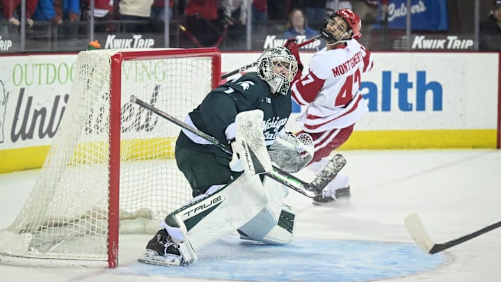 Michigan State goaltender Trey Augustine (1) and Wisconsin left wing Blake Montgomery (47) look for the puck in the air after Augustine deflected Montgomery’s shot in a game Thursday, January 15, 2026, at the Kohl Center in Madison, Wisconsin.