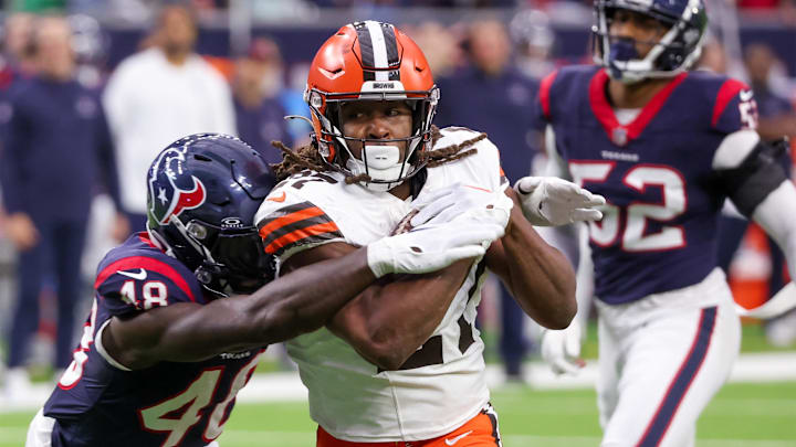 Jan 13, 2024; Houston, Texas, USA; Cleveland Browns running back Kareem Hunt (27) breaks the tackle of Houston Texans linebacker Christian Harris (48) as he scores a touchdown in a 2024 AFC wild card game at NRG Stadium. Mandatory Credit: Thomas Shea-Imagn Images