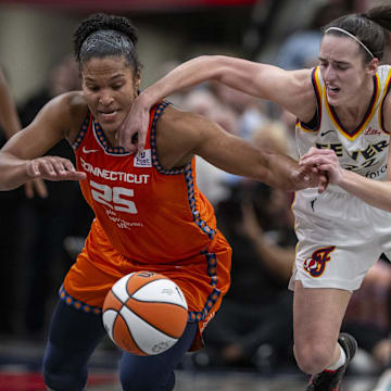 Connecticut Sun forward Alyssa Thomas (25) knocks the ball away from Indiana Fever guard Caitlin Clark (22) during the second half of an WNBA basketball game, Monday, May 20, 2024, at Gainbridge Fieldhouse.