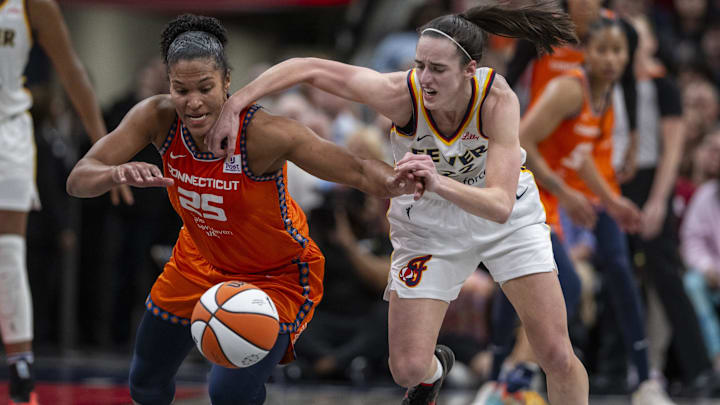 Connecticut Sun forward Alyssa Thomas (25) knocks the ball away from Indiana Fever guard Caitlin Clark (22) during the second half of an WNBA basketball game, Monday, May 20, 2024, at Gainbridge Fieldhouse.