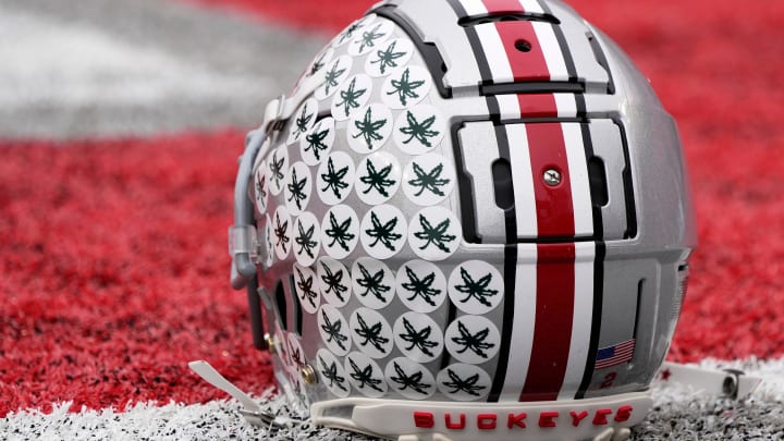 Oct. 1, 2022; Columbus, Ohio, USA; A stick-ladden Ohio State Buckeyes helmet sits on the turf during warmups before Saturday's game against the Rutgers Scarlet Knights in Columbus.