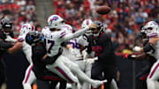 Oct 6, 2024; Houston, Texas, USA;  Buffalo Bills quarterback Josh Allen (17) gets hit by Houston Texans safety Jalen Pitre (5) in the second half at NRG Stadium. Mandatory Credit: Thomas Shea-Imagn Images