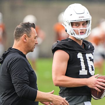 Head coach Steve Sarkisian talks to quarterback Arch Manning during the first Texas Longhorns football practice of 2023.