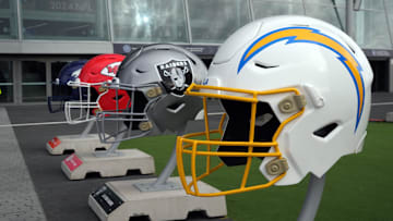 Oct 13, 2024; London, United Kingdom; Large helmets of the Los Angeles Chargers, Las Vegas Raiders, Kansas City Chiefs and Denver Broncos of the AFC West before an NFL International Series game at Tottenham Hotspur Stadium. Mandatory Credit: Kirby Lee-Imagn Images