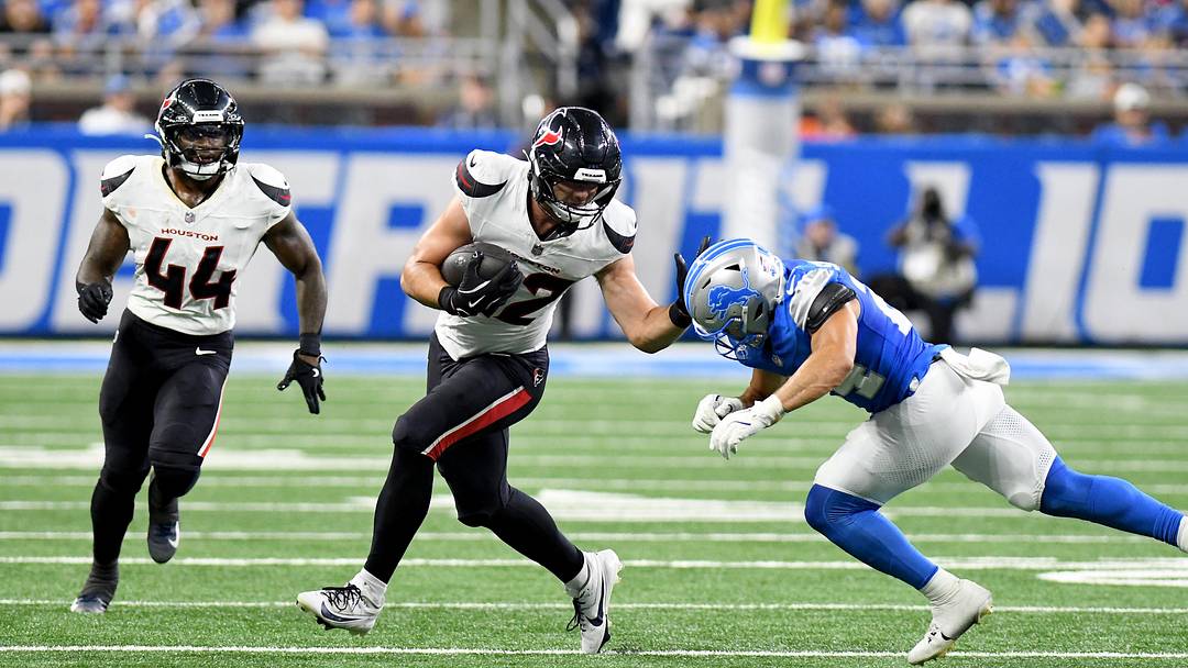 Aug 23, 2025; Detroit, Michigan, USA; Houston Texans tight end Luke Lachey (42) gets tackled by Detroit Lions safety Loren Strickland (24) in third quarter at Ford Field. Mandatory Credit: Eamon Horwedel-Imagn Images