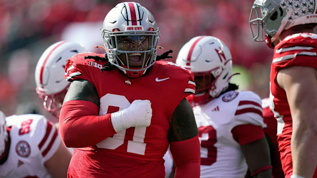 Ohio State Buckeyes defensive tackle Tyleik Williams (91) celebrates the tackle.