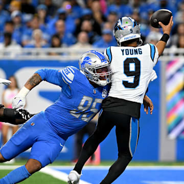 Oct 8, 2023; Detroit, Michigan, USA; Detroit Lions defensive end Romeo Okwara (95) nearly sacks Carolina Panthers quarterback Bryce Young (9) in the end zone in the third quarter at Ford Field. Okwara forced Young into an intentional grounding penalty on the play. Mandatory Credit: Lon Horwedel-Imagn Images