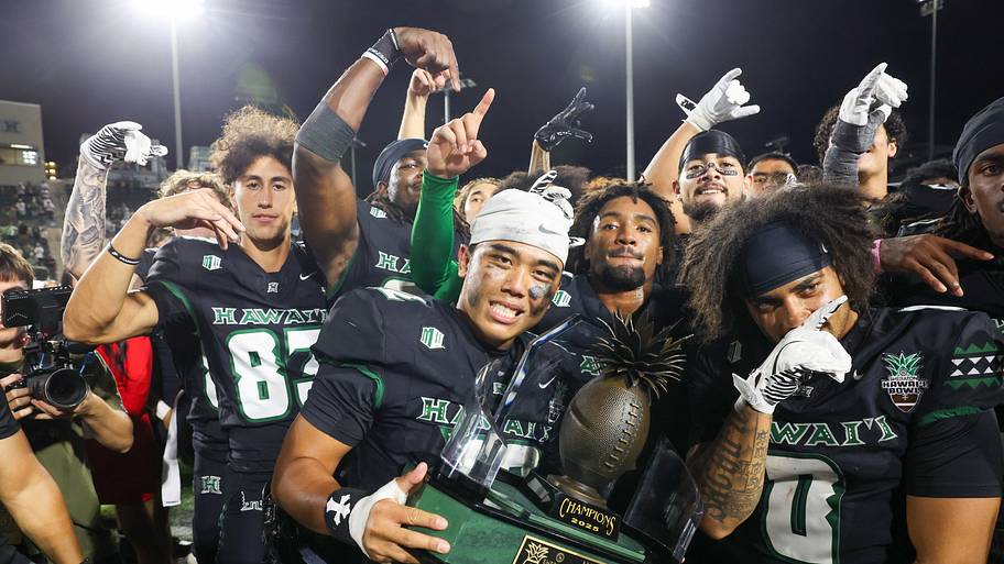 The Hawai’i Rainbow Warriors hold the winning trophy after defeating the California Golden Bears 53–31 in the Hawai’i Bowl.