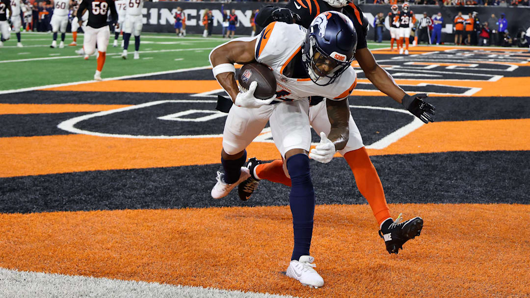 Dec 28, 2024; Cincinnati, Ohio, USA; Denver Broncos wide receiver Courtland Sutton (14) catches a touchdown pass as Cincinnati Bengals cornerback Josh Newton (28) defends during the third quarter at Paycor Stadium. Mandatory Credit: Joseph Maiorana-Imagn Images Dec 28, 2024; Cincinnati, Ohio, USA; Denver Broncos wide receiver Courtland Sutton (14) catches a touchdown pass as Cincinnati Bengals cornerback Josh Newton (28) defends during the third quarter at Paycor Stadium. Mandatory Credit: Joseph Maiorana-Imagn Images