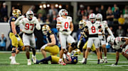 Ohio State Buckeyes linebacker Cody Simon (0) celebrates a tackle of Notre Dame Fighting Irish running back Jeremiyah Love (4) in the first quarter during the College Football Playoff National Championship at Mercedes-Benz Stadium in Atlanta on January 20, 2025.