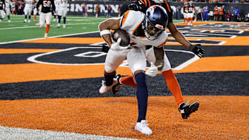 Dec 28, 2024; Cincinnati, Ohio, USA;  Denver Broncos wide receiver Courtland Sutton (14) catches a touchdown pass as Cincinnati Bengals cornerback Josh Newton (28) defends during the third quarter at Paycor Stadium. Mandatory Credit: Joseph Maiorana-Imagn Images