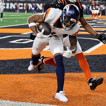Dec 28, 2024; Cincinnati, Ohio, USA;  Denver Broncos wide receiver Courtland Sutton (14) catches a touchdown pass as Cincinnati Bengals cornerback Josh Newton (28) defends during the third quarter at Paycor Stadium. Mandatory Credit: Joseph Maiorana-Imagn Images