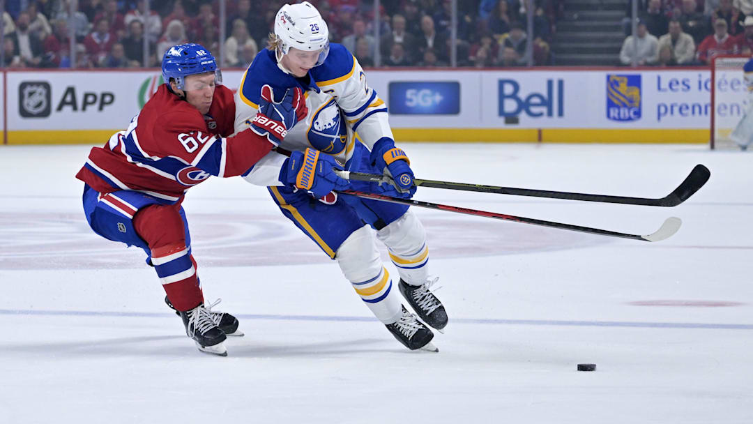 Oct 20, 2025; Montreal, Quebec, CAN; Montreal Canadiens forward Owen Beck (62) and Buffalo Sabres defenseman Rasmus Dahlin (26) battle for the puck during the second period at the Bell Centre. Mandatory Credit: Eric Bolte-Imagn Images