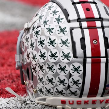 Oct. 1, 2022; Columbus, Ohio, USA; A stick-ladden Ohio State Buckeyes helmet sits on the turf during warmups before Saturday's game against the Rutgers Scarlet Knights in Columbus. Mandatory Credit: Barbara Perenic/Columbus Dispatch

Sports Ohio State Rutgers Ncaa Football