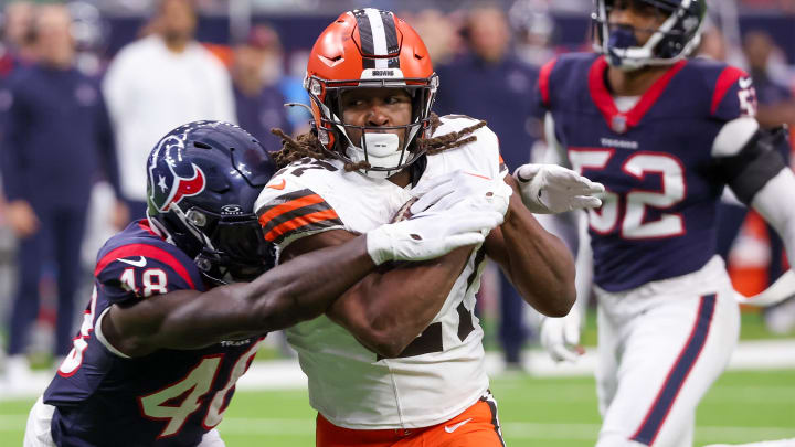 Jan 13, 2024; Houston, Texas, USA; Cleveland Browns running back Kareem Hunt (27) breaks the tackle of Houston Texans linebacker Christian Harris (48) as he scores a touchdown in a 2024 AFC wild card game at NRG Stadium.