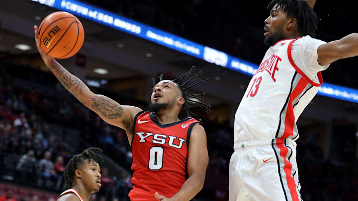 Nov 11, 2024; Columbus, Ohio, USA;  Youngstown State Penguins guard Ty Harper (1) attempts a shot as Ohio State Buckeyes forward Sean Stewart (13) defends during the first half at Value City Arena. Mandatory Credit: Joseph Maiorana-Imagn Images