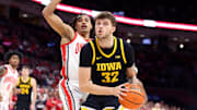 Jan 27, 2025; Columbus, Ohio, USA;  Iowa Hawkeyes forward Owen Freeman (32) controls the ball as Ohio State Buckeyes forward Devin Royal (21) defends during the first half at Value City Arena. Mandatory Credit: Joseph Maiorana-Imagn Images
