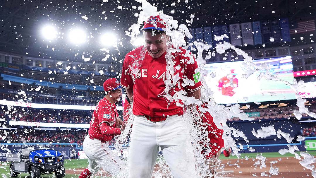 Toronto Blue Jays designated hitter Sean Keys (20) gets the water bucket poured on him. Toronto Blue Jays designated hitter Sean Keys (20) gets the water bucket poured on him.