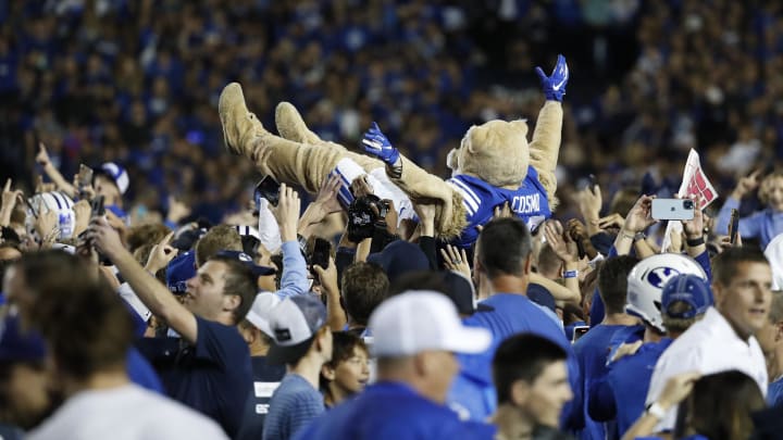 Sep 11, 2021; Provo, Utah, USA; Brigham Young Cougars mascot Cosmo body surfs as fans stormed the field after their win over the Utah Utes at LaVell Edwards Stadium. Mandatory Credit: Jeffrey Swinger-USA TODAY Sports