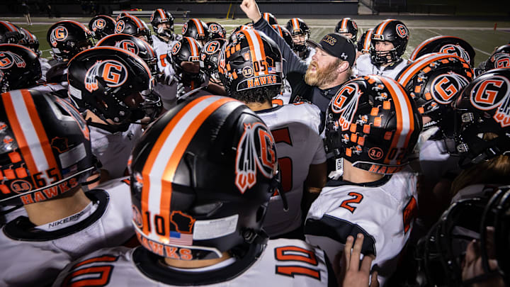Grafton coach Jim Norris celebrates with his team after a 34-31 overtime win over Catholic Memorial in a WIAA Division 3 state semifinal Friday, November 14, 2025, at Oconomowoc High School in the Oconomowoc, Wisconsin.