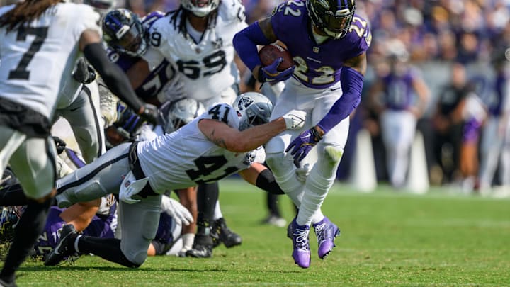 Sep 15, 2024; Baltimore, Maryland, USA; Baltimore Ravens running back Derrick Henry (22) runs the ball while being tackled by Las Vegas Raiders linebacker Robert Spillane (41) during the second half at M&T Bank Stadium. Mandatory Credit: Reggie Hildred-Imagn Images