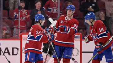 Oct 4, 2022; Montreal, Quebec, CAN; Montreal Canadiens forward Cole Caufield (22) celebrates with teammates including forward Juraj Slafkovsky (20) and forward Nick Suzuki (14) after scoring a goal against the Ottawa Senators during the third period at the Bell Centre. Mandatory Credit: Eric Bolte-USA TODAY Sports