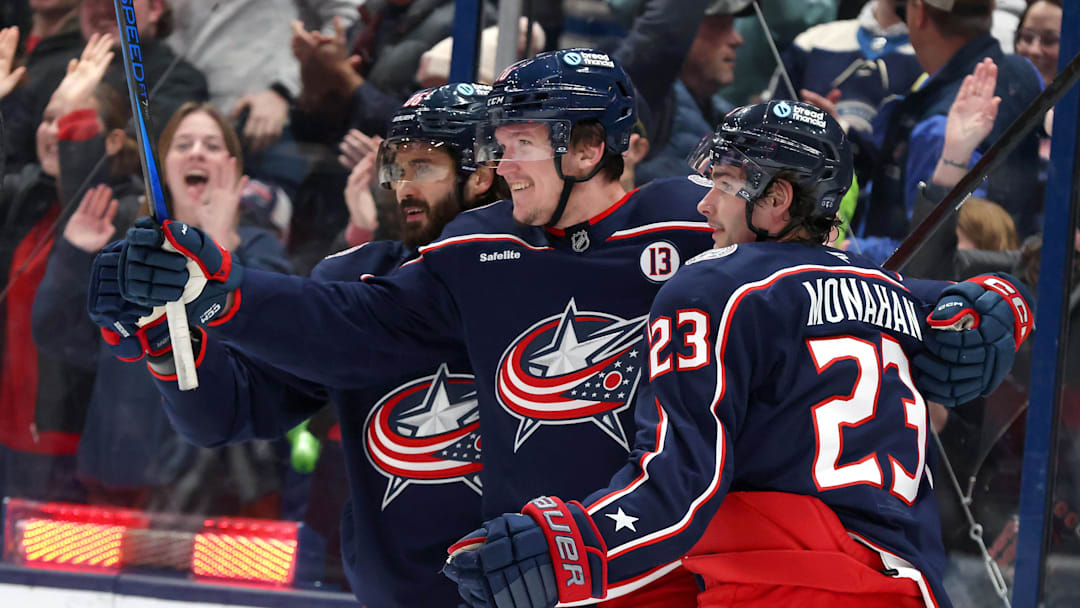 Jan 4, 2025; Columbus, Ohio, USA;  Columbus Blue Jackets left wing Dmitri Voronkov (middle) celebrates with center Sean Monahan (23) and right wing Kirill Marchenko (86) after scoring a goal against the St. Louis Blues during the first period at Nationwide Arena. Mandatory Credit: Joseph Maiorana-Imagn Images