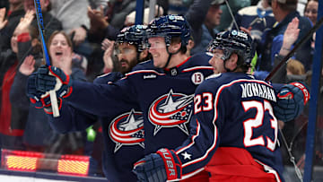 Jan 4, 2025; Columbus, Ohio, USA;  Columbus Blue Jackets left wing Dmitri Voronkov (middle) celebrates with center Sean Monahan (23) and right wing Kirill Marchenko (86) after scoring a goal against the St. Louis Blues during the first period at Nationwide Arena. Mandatory Credit: Joseph Maiorana-Imagn Images