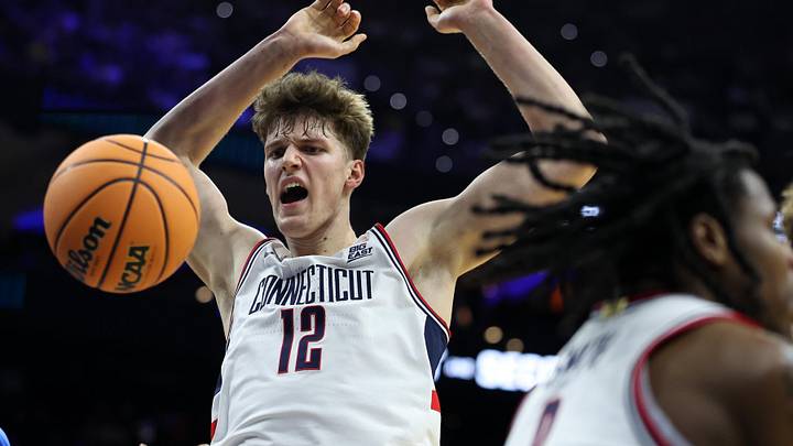 Mar 22, 2026; Philadelphia, PA, USA; UConn Huskies center Eric Reibe (12) dunks the ball against the UCLA Bruins in the first half during a second round game of the men's 2026 NCAA Tournament at Xfinity Mobile Arena. Mandatory Credit: Bill Streicher-Imagn Images