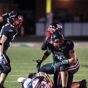 Muskego linebackers Jayden Adams (7), Logan Limberg (33) and Brody Axelson (45) and defensive lineman Caleb Hein (30) celebrate a sack versus Arrowhead in a Classic 8 Conference game Friday, September 19, 2025.