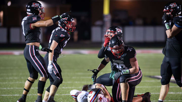 Muskego linebackers Jayden Adams (7), Logan Limberg (33) and Brody Axelson (45) and defensive lineman Caleb Hein (30) celebrate a sack versus Arrowhead in a Classic 8 Conference game Friday, September 19, 2025.