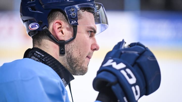 Milwaukee Admirals left wing Egor Afanasyev (70), one of the few players on his team to wear a neck guard, stands near the bench during practice Thursday, April 11, 2024, at UW-Milwaukee Panther Arena in Milwaukee, Wisconsin.