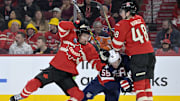 Feb 15, 2025; Montreal, Quebec, CAN; [Imagn Images direct customers only] Team Canada forward Mark Stone (61) and teammate Team Canada defenseman Thomas Harley (48) check Team United States forward Jake Guentzel (59) in the third period during a 4 Nations Face-Off ice hockey game at the Bell Centre. Mandatory Credit: Eric Bolte-Imagn Images