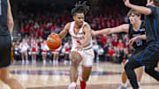 Fishers High School sophomore Jason Gardner (5) drives the ball against the defense of Hamilton Southeastern High School senior Braeden Totton (13) during the first half of an IHSAA basketball game, Friday, Dec. 20, 2024, at Fishers Event Center.