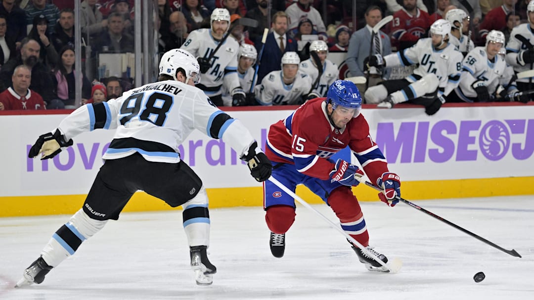 Nov 8, 2025; Montreal, Quebec, CAN; Montreal Canadiens forward Alex Newhook (15) plays the puck and Utah Mammoth defenseman Mikhail Sergachev (98) defends during the first period at the Bell Centre. Mandatory Credit: Eric Bolte-Imagn Images
