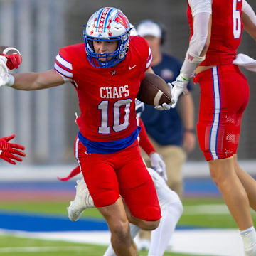 Westlake wideout Cal Livengood stiff-arms Atascosita's Hunter Sowell during the first half on Friday, Sept 13 at Westlake High School.