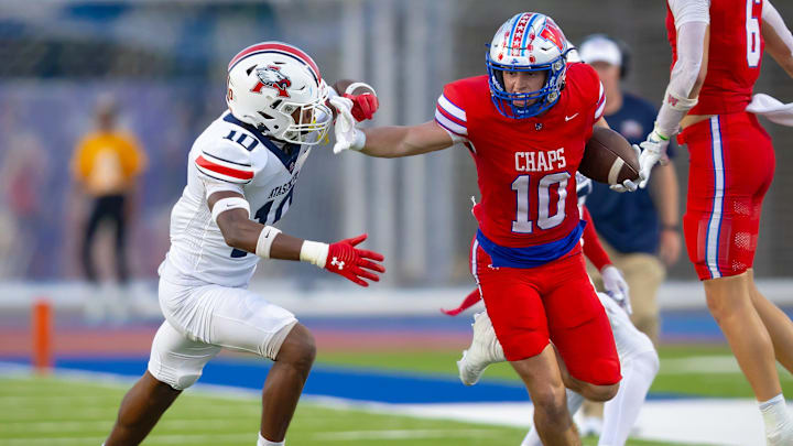 Westlake wideout Cal Livengood stiff-arms Atascosita's Hunter Sowell during the first half on Friday, Sept 13 at Westlake High School.