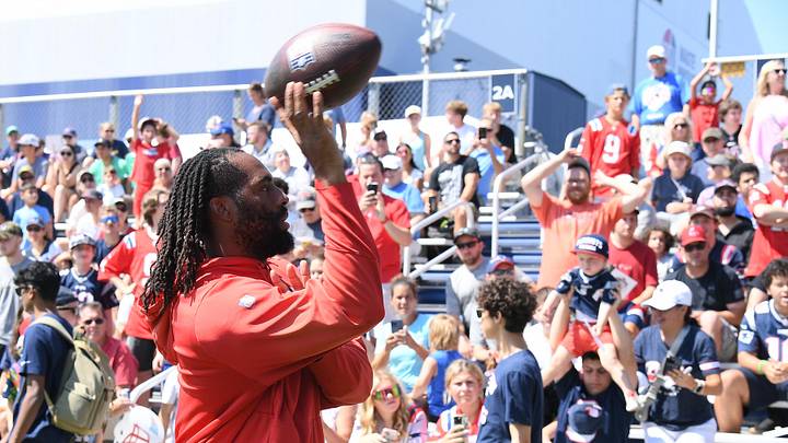 Jul 26, 2024; Foxborough, MA, USA; New England Patriots linebacker Matthew Judon (9) tosses a ball to fans during training camp at Gillette Stadium. Mandatory Credit: Eric Canha-USA TODAY Sports