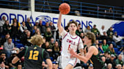 Slinger forward Joey Kohnen (1) passes the ball over the double-team of Freedom guards Sawyer Rueckl (12) and Kaden Vandenberg (4) in a game in the Rick Majerus WBY Shootout on Friday, December 27, 2024, at Concordia University in Mequon, Wisconsin.