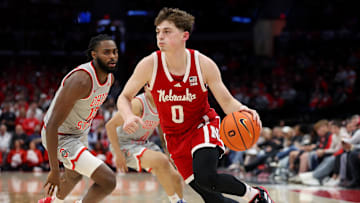 Mar 4, 2025; Columbus, Ohio, USA; Nebraska Cornhuskers guard Connor Essegian (0) drives to the basket as Ohio State Buckeyes guard Evan Mahaffey (12) defends during the first half at Value City Arena.