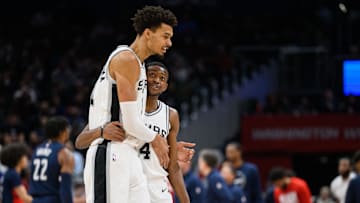 Feb 10, 2025; Washington, District of Columbia, USA; San Antonio Spurs center Victor Wembanyama (1) and guard De'Aaron Fox (4) react during the second quarter against the Washington Wizards at Capital One Arena. Mandatory Credit: Reggie Hildred-Imagn Images