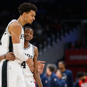 Feb 10, 2025; Washington, District of Columbia, USA; San Antonio Spurs center Victor Wembanyama (1) and guard De'Aaron Fox (4) react during the second quarter against the Washington Wizards at Capital One Arena. Mandatory Credit: Reggie Hildred-Imagn Images
