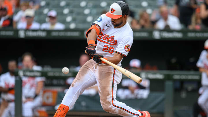 Jul 31, 2024; Baltimore, Maryland, USA; Baltimore Orioles outfielder Anthony Santander (25) hits a single against the Toronto Blue Jays during the fifth inning at Oriole Park at Camden Yards.