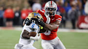 Nov 15, 2025; Columbus, Ohio, USA; UCLA Bruins running back Anthony Woods (6) runs the ball as Ohio State Buckeyes linebacker Sonny Styles (0) makes the tackle on the play during the second quarter at Ohio Stadium. Mandatory Credit: Joseph Maiorana-Imagn Images