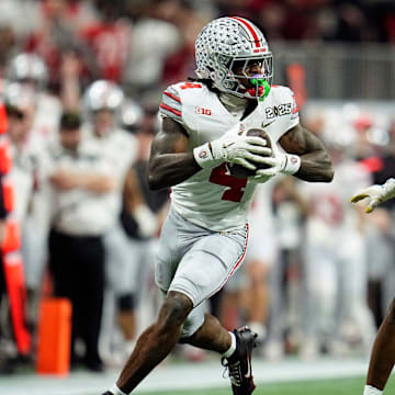 Ohio State Buckeyes wide receiver Jeremiah Smith (4) makes a catch against Notre Dame Fighting Irish cornerback Christian Gray (29) in the fourth quarter during the College Football Playoff National Championship at Mercedes-Benz Stadium in Atlanta on January 20, 2025.