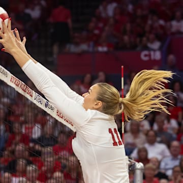 Nebraska middle blocker Leyla Blackwell (right) wins a battle at the net against The Citadel.