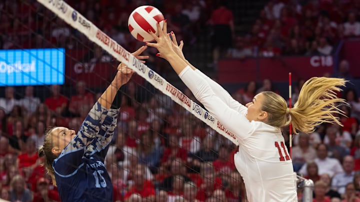 Nebraska middle blocker Leyla Blackwell (right) wins a battle at the net against The Citadel.