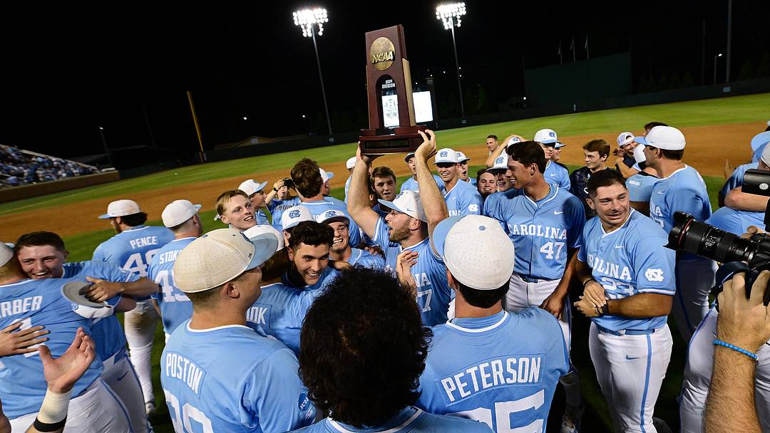 UNC baseball players lift the Super Regional trophy